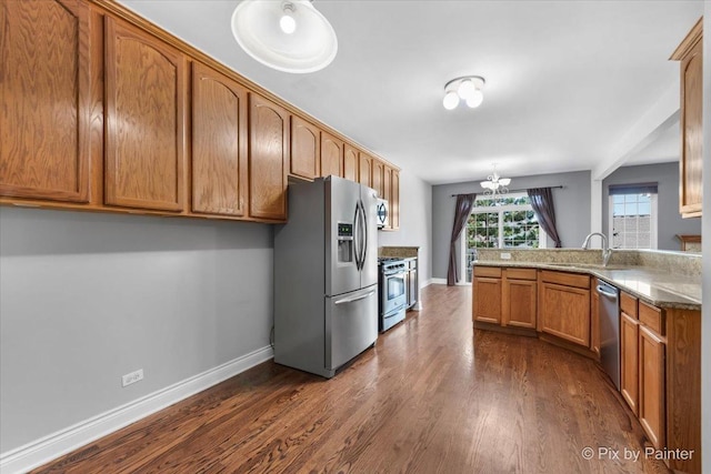 18104 Lake Shore Dr, Orland Park, IL 60467 - kitchen featuring appliances with stainless steel finishes, dark wood-style floors, brown cabinets, and baseboards
