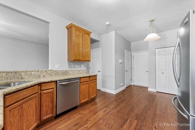 18104 Lake Shore Dr, Orland Park, IL 60467 - kitchen featuring appliances with stainless steel finishes, dark wood-style flooring, light stone counters, and pendant lighting