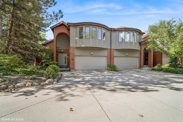 3305 Old Glenview Rd Unit A, Wilmette, IL 60091 - view of front facade featuring brick siding, a garage, and driveway