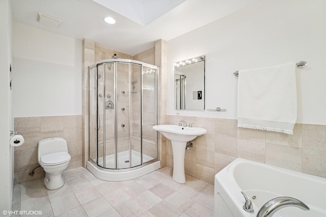 3305 Old Glenview Rd Unit A, Wilmette, IL 60091 - full bathroom with tile walls, a shower stall, a wainscoted wall, a tub with jets, and toilet