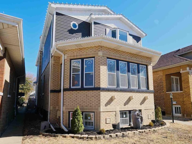 view of property exterior featuring brick siding