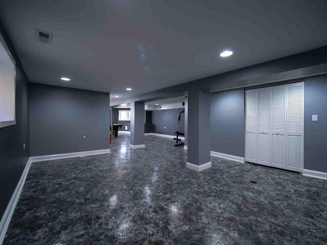 finished basement with baseboards and recessed lighting