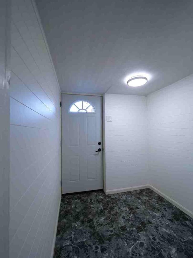 doorway to outside with baseboards