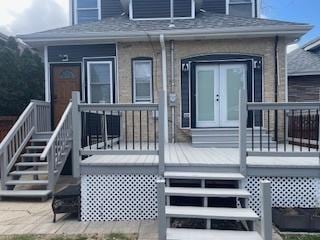 property entrance with roof with shingles and french doors