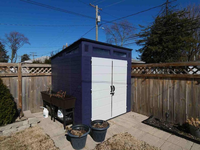 view of shed featuring a fenced backyard