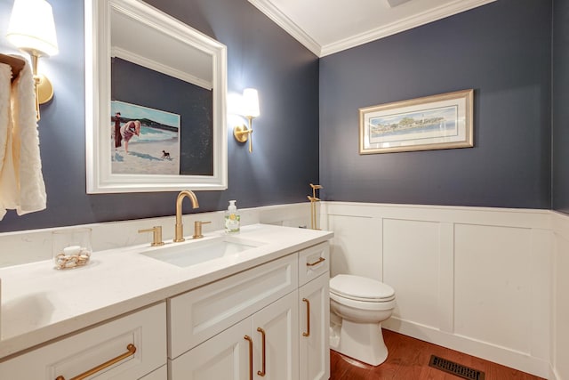 1111 S Waukegan Rd Unit 10, Lake Forest, IL 60045 - bathroom with crown molding, vanity, toilet, wood finished floors, and wainscoting