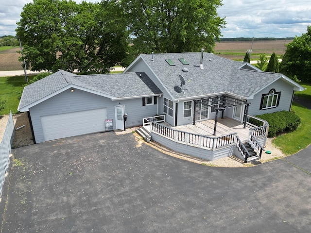 1988 S Chana Rd, Chana, IL 61015 - ranch-style house with asphalt driveway, roof with shingles, a garage, and a deck