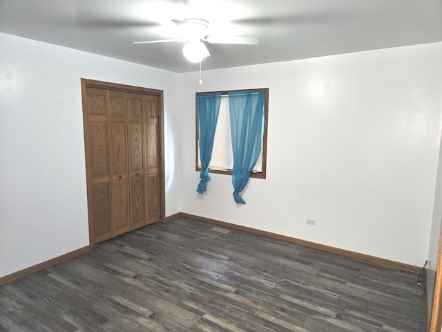 1988 S Chana Rd, Chana, IL 61015 - unfurnished bedroom with dark wood-type flooring, a closet, and baseboards