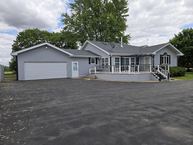 1988 S Chana Rd, Chana, IL 61015 - ranch-style home with driveway, a garage, roof with shingles, and a wooden deck