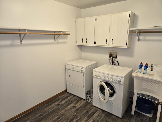 1988 S Chana Rd, Chana, IL 61015 - washroom featuring cabinet space, washing machine and clothes dryer, dark wood-style floors, and baseboards