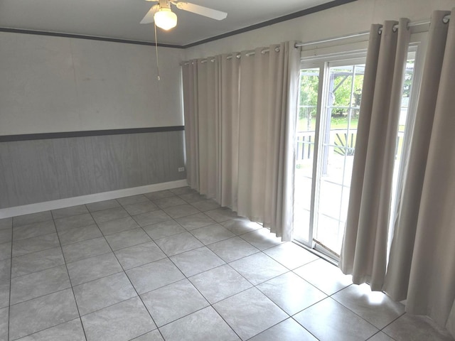 1988 S Chana Rd, Chana, IL 61015 - unfurnished room with a ceiling fan, light tile patterned floors, and wainscoting