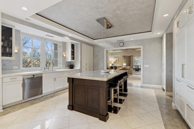 kitchen featuring dishwasher, a tray ceiling, glass insert cabinets, white cabinetry, and recessed lighting