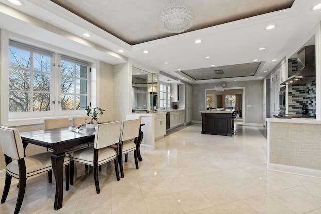 dining area with a tray ceiling, recessed lighting, baseboards, light tile patterned floors, and a chandelier