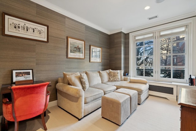 living area with crown molding, radiator heating unit, wallpapered walls, light carpet, and baseboards