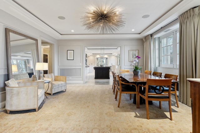 dining area featuring a tray ceiling and light colored carpet
