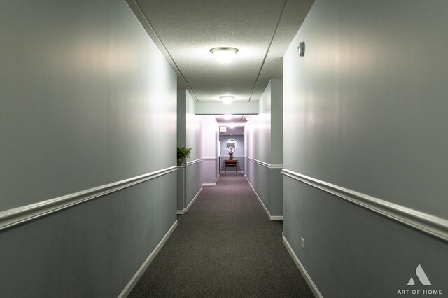 3940 W Bryn Mawr Ave Unit 403, Chicago, IL 60659 - corridor with dark colored carpet, baseboards, and a textured ceiling