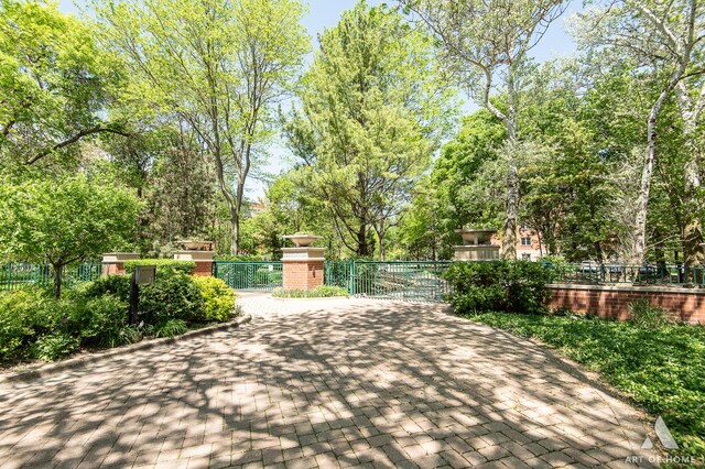 3940 W Bryn Mawr Ave Unit 403, Chicago, IL 60659 - view of patio featuring a gate and view of scattered trees