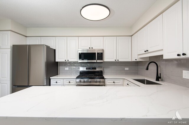 3940 W Bryn Mawr Ave Unit 403, Chicago, IL 60659 - kitchen featuring stainless steel appliances, a sink, light stone counters, white cabinets, and backsplash