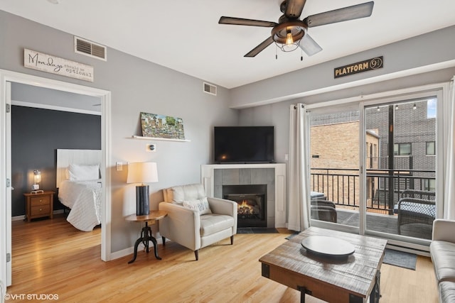 437 W N Ave Unit 404, Chicago, IL 60610 - living room with a ceiling fan, light wood-style floors, and a tiled fireplace