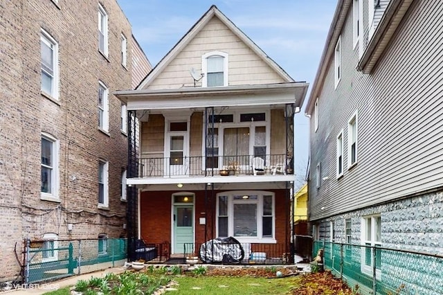 1655 N Francisco Ave, Chicago, IL 60647 - view of front facade featuring a balcony, a porch, and a fenced backyard