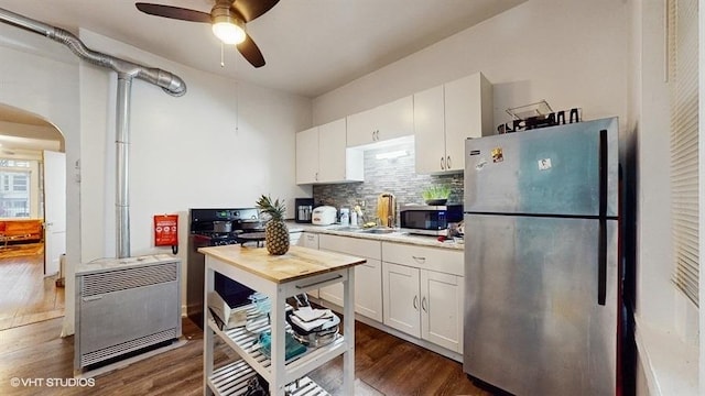1655 N Francisco Ave, Chicago, IL 60647 - kitchen featuring stainless steel appliances, light countertops, decorative backsplash, and ceiling fan