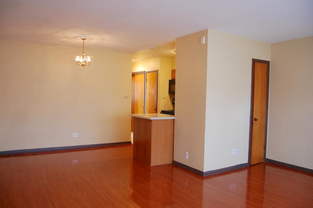 1001 N Harlem Ave Unit A, Oak Park, IL 60302 - empty room with wood finished floors, a chandelier, and baseboards