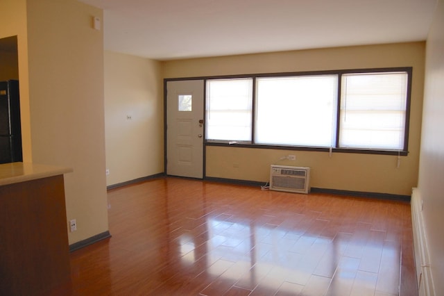 1001 N Harlem Ave Unit A, Oak Park, IL 60302 - spare room featuring a wall mounted air conditioner, wood finished floors, and baseboards