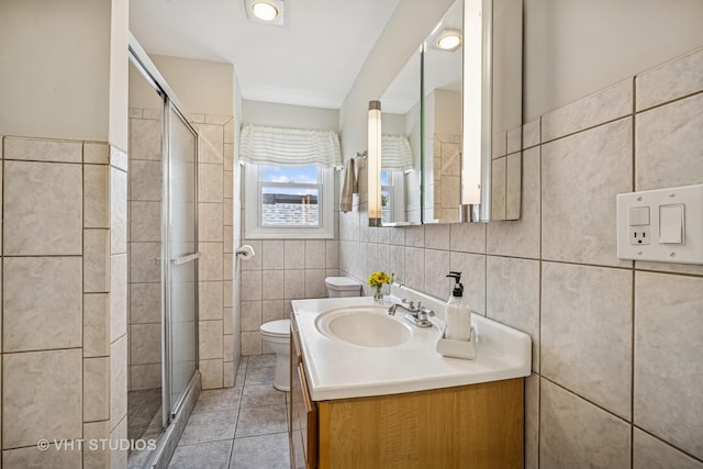 4101 N Ozark Ave, Norridge, IL 60706 - full bath featuring tile walls, toilet, a stall shower, vanity, and tile patterned floors
