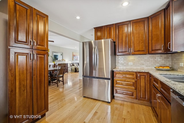 4101 N Ozark Ave, Norridge, IL 60706 - kitchen with appliances with stainless steel finishes, light wood-style floors, light stone countertops, decorative backsplash, and recessed lighting