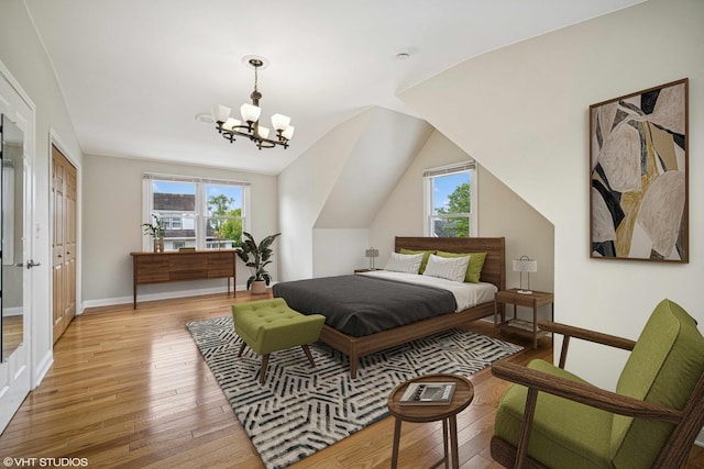 4101 N Ozark Ave, Norridge, IL 60706 - bedroom featuring multiple windows, light wood-style flooring, a chandelier, baseboards, and lofted ceiling