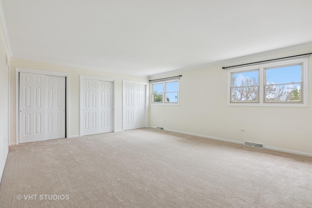 12809 W Meadowview Ln, Homer Glen, IL 60491 - unfurnished bedroom featuring crown molding, carpet, two closets, and baseboards