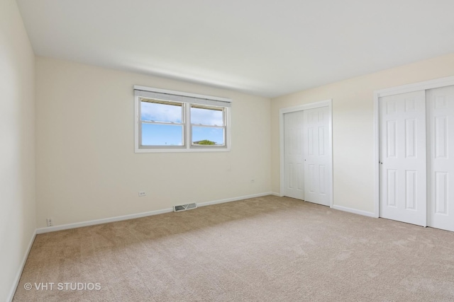 12809 W Meadowview Ln, Homer Glen, IL 60491 - unfurnished bedroom with two closets, carpet flooring, and baseboards