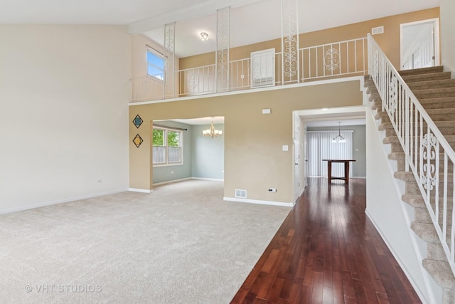 12809 W Meadowview Ln, Homer Glen, IL 60491 - unfurnished living room with a chandelier, stairs, baseboards, hardwood / wood-style flooring, and high vaulted ceiling