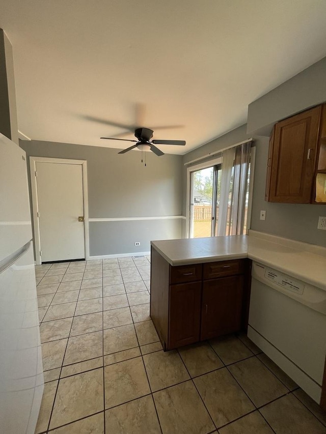 235 Lexington Dr, Bolingbrook, IL 60440 - kitchen with white appliances, a peninsula, a ceiling fan, light tile patterned floors, and light countertops