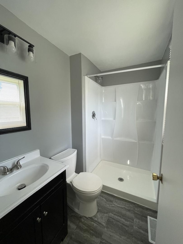 235 Lexington Dr, Bolingbrook, IL 60440 - bathroom featuring a shower, toilet, and vanity
