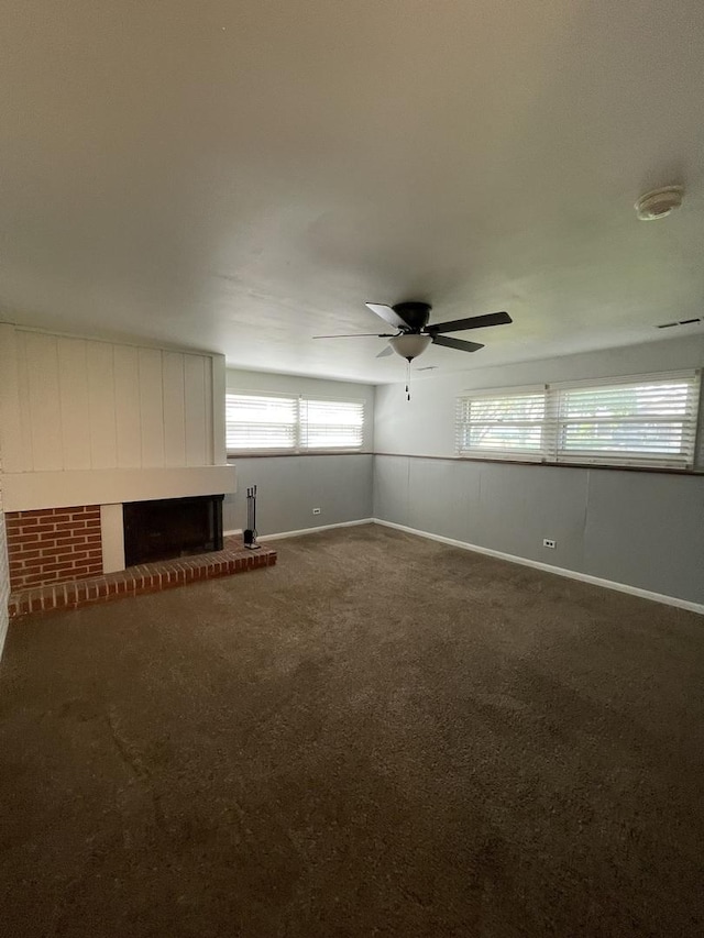 235 Lexington Dr, Bolingbrook, IL 60440 - unfurnished living room with ceiling fan, a brick fireplace, dark colored carpet, and baseboards