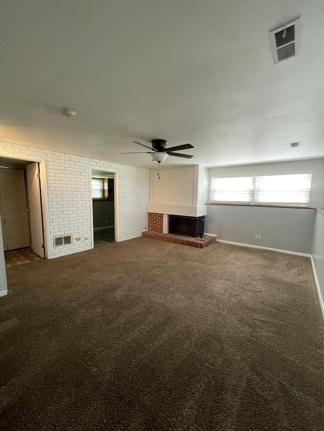 235 Lexington Dr, Bolingbrook, IL 60440 - unfurnished living room with ceiling fan, a fireplace with raised hearth, carpet flooring, brick wall, and baseboards