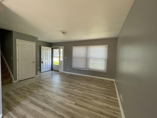 235 Lexington Dr, Bolingbrook, IL 60440 - foyer with baseboards, light wood-style flooring, and stairway
