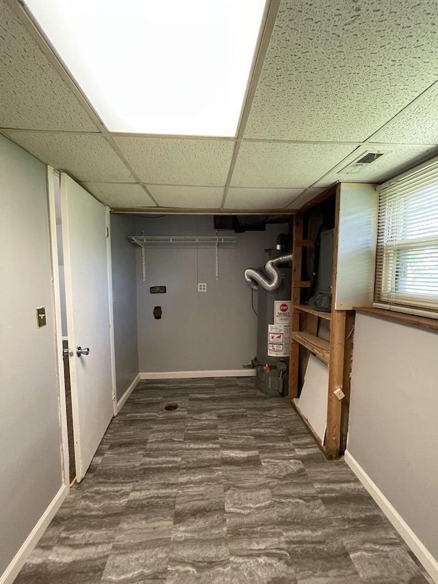 235 Lexington Dr, Bolingbrook, IL 60440 - basement with water heater, a paneled ceiling, baseboards, and dark wood finished floors