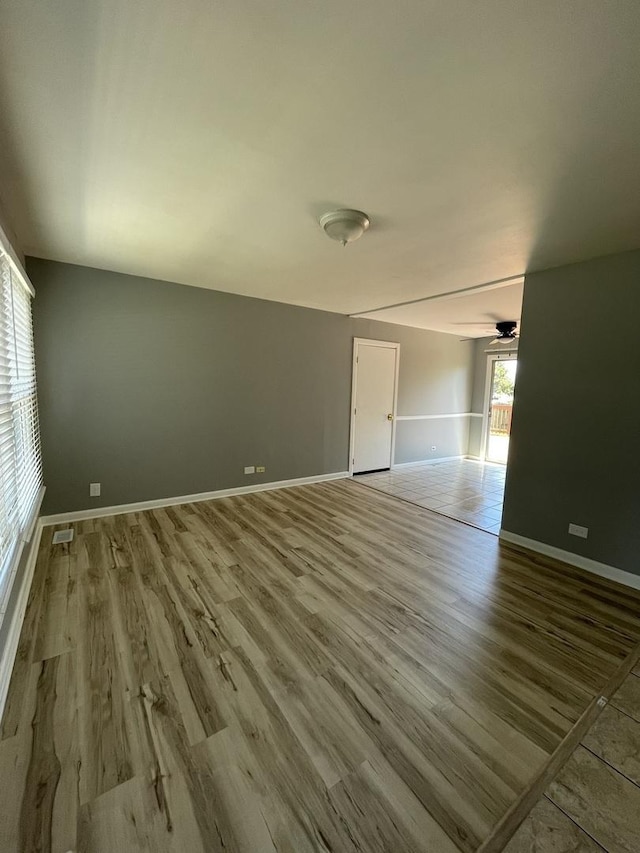 235 Lexington Dr, Bolingbrook, IL 60440 - spare room featuring wood finished floors, baseboards, and ceiling fan