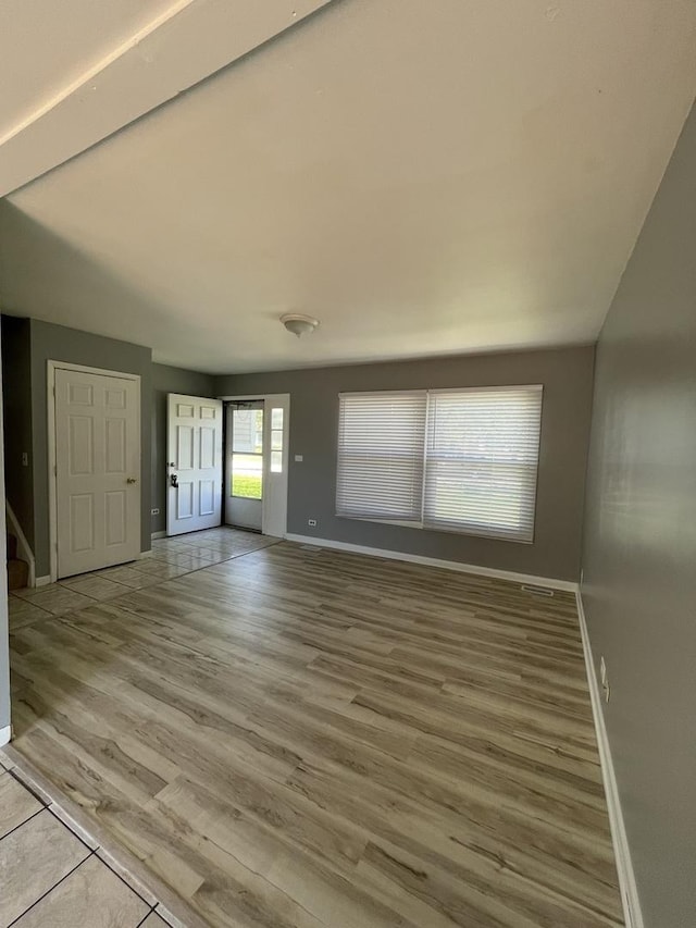 235 Lexington Dr, Bolingbrook, IL 60440 - unfurnished living room featuring baseboards, light wood-type flooring, and stairway