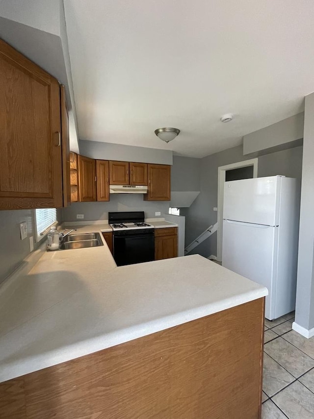 235 Lexington Dr, Bolingbrook, IL 60440 - kitchen featuring freestanding refrigerator, gas stove, a sink, under cabinet range hood, and a peninsula