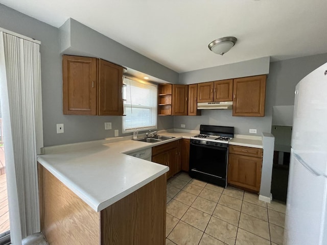 235 Lexington Dr, Bolingbrook, IL 60440 - kitchen with gas range, freestanding refrigerator, a peninsula, under cabinet range hood, and light countertops