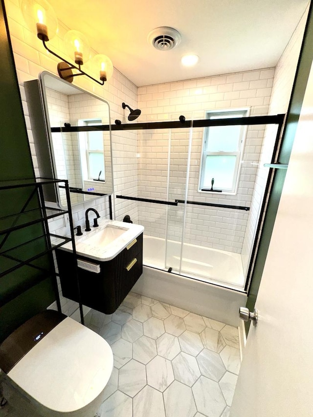 120 E 15th St, Lombard, IL 60148 - full bath with bath / shower combo with glass door, vanity, toilet, and tile patterned floors