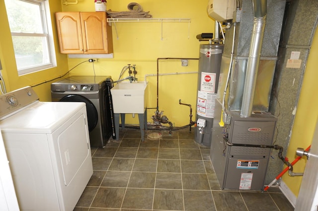 120 E 15th St, Lombard, IL 60148 - laundry room featuring cabinet space, washer and clothes dryer, water heater, dark tile patterned flooring, and baseboards