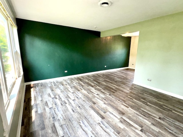 120 E 15th St, Lombard, IL 60148 - unfurnished room with plenty of natural light, wood finished floors, and baseboards