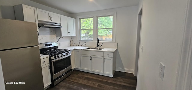 307 Bevier Pl, Aurora, IL 60505 - kitchen with appliances with stainless steel finishes, a sink, under cabinet range hood, dark wood-type flooring, and light countertops