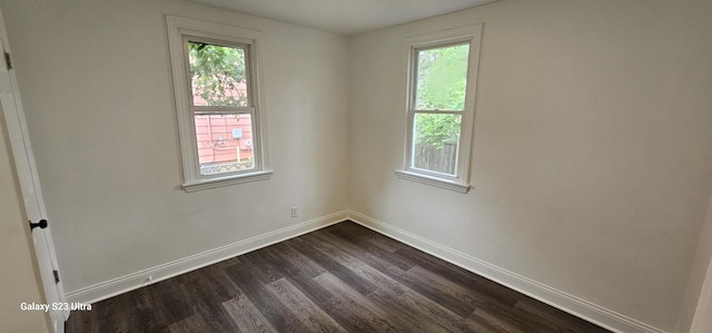 307 Bevier Pl, Aurora, IL 60505 - spare room with dark wood-type flooring, healthy amount of natural light, and baseboards