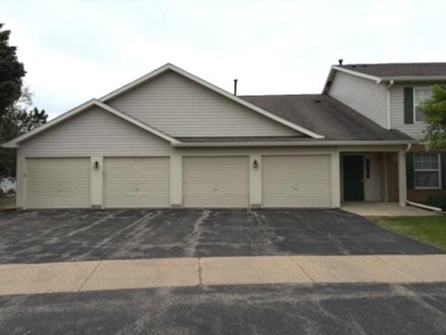1127 N Red Oak Cir Unit 2, Round Lake Beach, IL 60073 - view of front facade featuring an attached garage and driveway