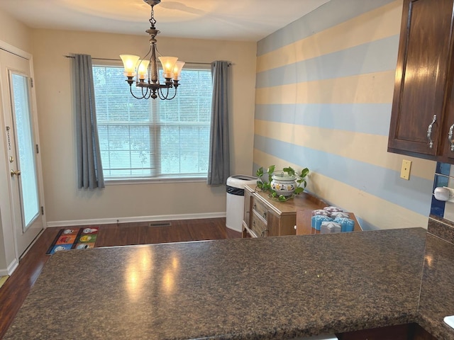 1127 N Red Oak Cir Unit 2, Round Lake Beach, IL 60073 - dining area featuring a chandelier, dark wood-style floors, and baseboards